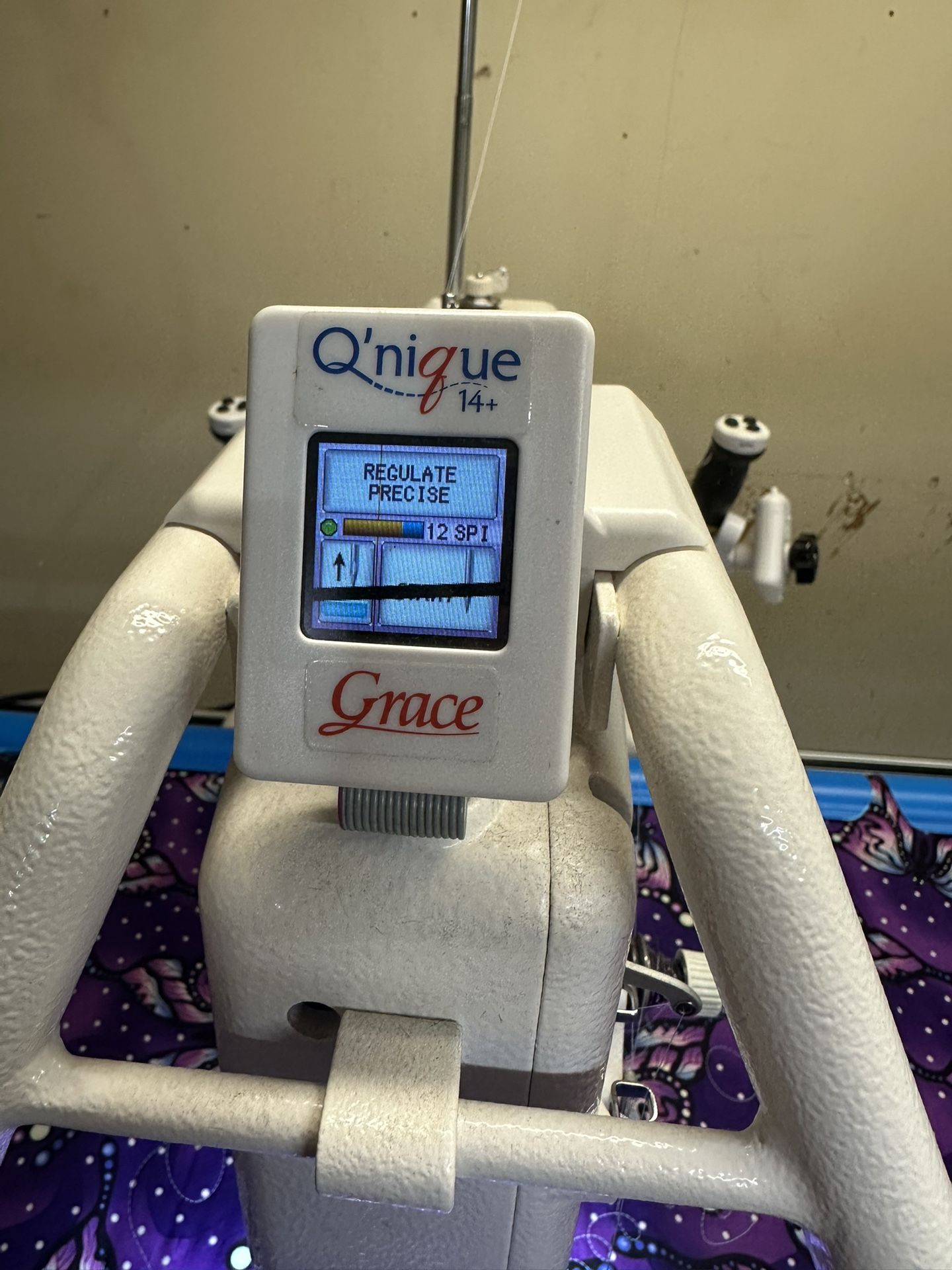 Q’nique 14+ quilting machine with a 10-foot quilting frame