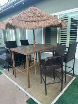 Outdoor faux wood table with 4 wicker chairs