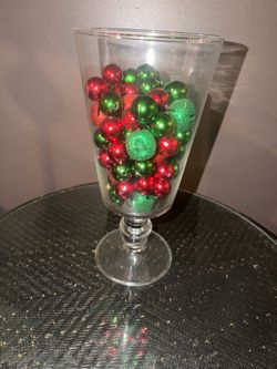 14” CLEAR GLASS PEDESTAL VASE  FILLED WITH GREEN & RED ORNAMENTS