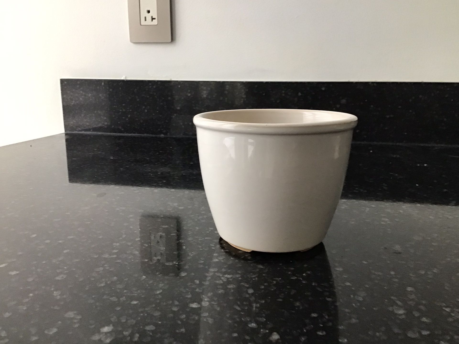 small white ceramic planter pot with drainage hole 