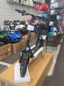 Electric scooter with seat and storage basket great for city commute to work and run errands
