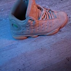 Air Jordan 13 Retro "Wheat" sneakers in an elemental gold, baroque brown, and gum yellow colorway. 