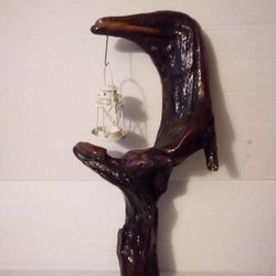 Unique handcrafted driftwood sculpture with candle light lantern.  Has a fastren on the back for hanging. Driftwood is from the banks of the Susquehan