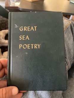 A leather-bound book titled "Great Sea Poetry" by Bascom.