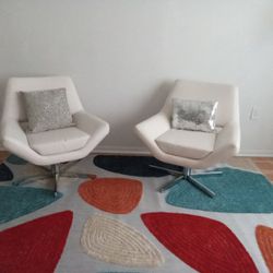 Two White Swivel Loungers