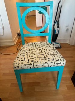 Blue wooden chair with upholstered cushion