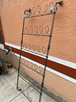Metal shoe rack for 18 pairs; measures 59 inches high and 25 inches long.