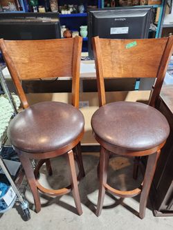 Pair of brown wood swivel stools with backs $50 ea
