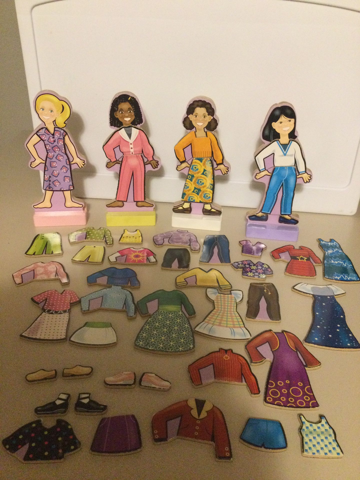 Wooden dolls 7.5” tall  and magnetic clothing more than 40 pieces