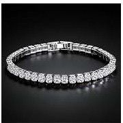 Elegant sterling silver tennis bracelet is crafted with a continuous row of round-cut cubic zirconia stones. The piece has a secure box clasp with saf