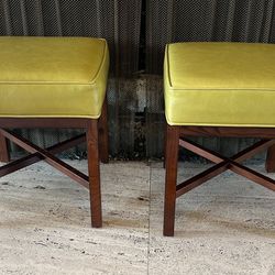 Two low stools with green leather cushion