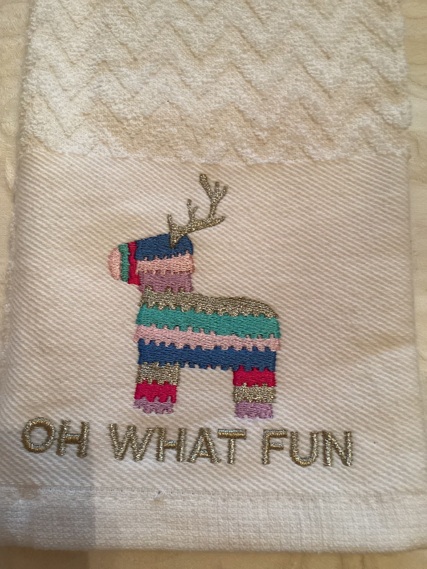 White hand towel with colorful reindeer design and 'Oh What Fun' text 16x26”