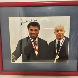 Muhammad  Ali  autographed  photo wearing  Olympic gold medal with Joe Diamaggio, includes autographed  boxing gloves and books about him