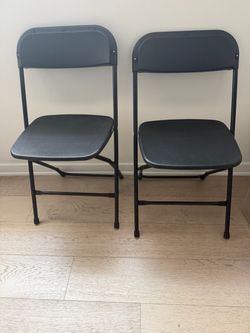 2 indoor/ outdoor black folding chairs