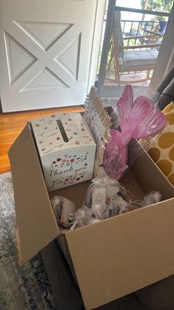 Box of free girl baby shower stuff