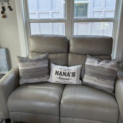 Gray/beige leather loveseat, recliner and dual head rest