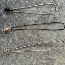 2 Mens new without tags small skulls. One iridescent and one gold. Both come with chains. 2 chains 1 price. 