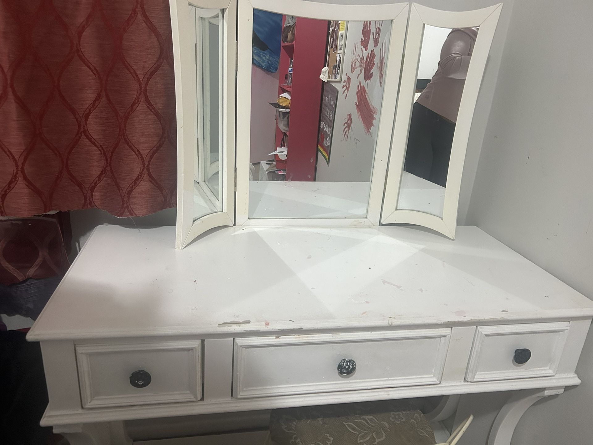 white wooden vanity desk with a three-panel mirror and three drawers