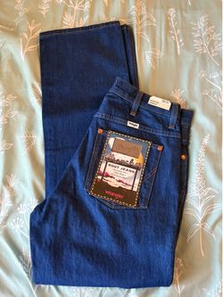 Wrangler "Cowboy Cut" or "Bootcut" jeans featuring a prominent product tag on the back pocket.