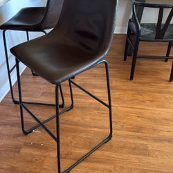 Three brown bar stools