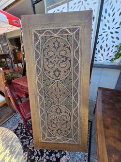 Moroccan-style decorative wall panel with intricate carved or embroidered details.