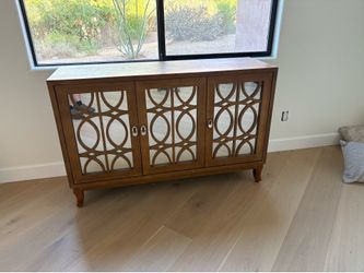 Elegant wood accent cabinet / sideboard with decorative mirrored doors.