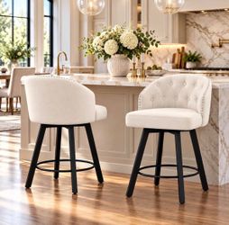 26” counter height swivel bar stools in beige fabric with a black frame.