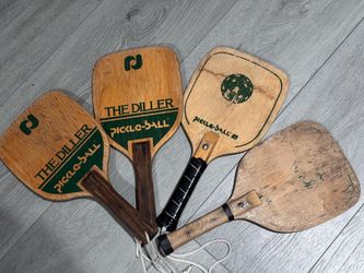 Four wooden vintage pickleball paddles