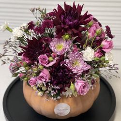 Handmade fall floral bouquet in a real pumpkin