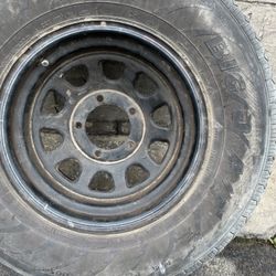 One black 15x8 steel rim and old tire 5 on 5.5 Dodge, Ford, Jeep 