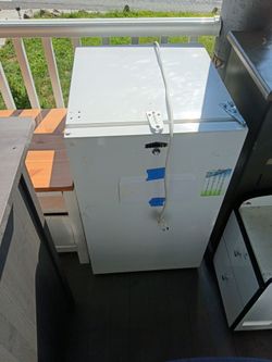 Mini fridge , antique dresser and two microwaves