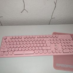 Pink keyboard with mouse and mouse pad