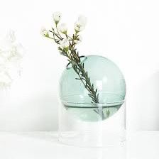Round globe teal Glass Vase in Light Blue   Enhance your home decor with this small glass vase. Its light blue hue adds a touch of sophistication to a