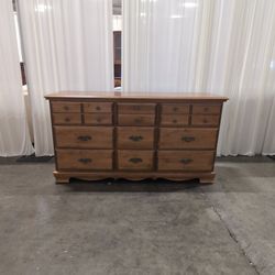 Traditional Brown Wood Nine-Drawer Dresser with Ornate Hardware