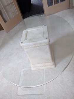 Cocktail glass table and two end tables. Unique table base. The table glass top is thick and strong.