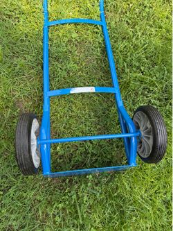 Durable steel hand truck has a blue powder-coated finish. This dolly features two solid rubber wheels and a flat toe plate for lifting heavy loads. Th