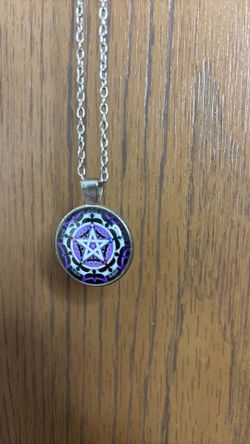 Pendant with purple star pattern on a silver chain with a lobster claw clasp