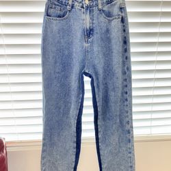 Blue denim jeans with a distressed finish Medium-wash blue denim jeans with a straight-leg fit and raw frayed hems for a relaxed, worn-in feel.