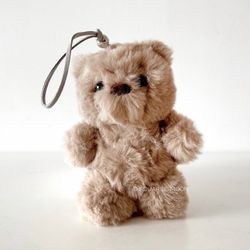 Ariana Grande r.e.m. beauty teddy bear lippy holder keychain + lip balm in hand