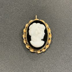 Vintage 12K yellow gold filled cameo brooch/pendant. Measures 1 1/8" X 7/8". The brooch has a roll over safety on the back as well as a fold up bail t