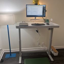 At home office setup: Standing desk (electric), ergonomic chair, 4k monitor, Logi 1080P webcam 