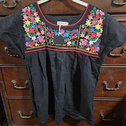 Mexican embroidered blouse, a Puebla blouse, or a Mexican peasant blouse