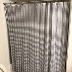 Grey and white stripped shower curtain with hooks