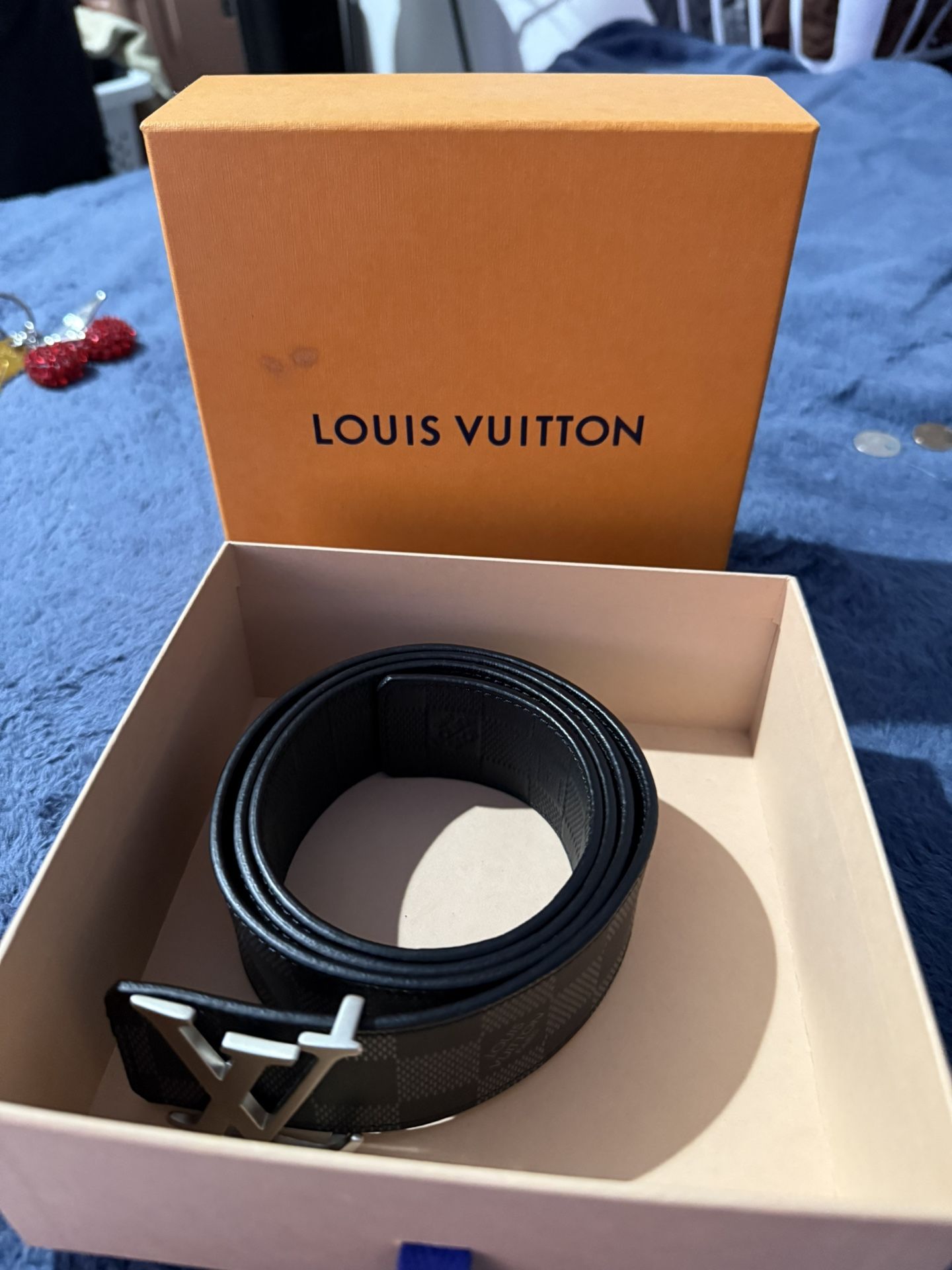 Louis Vuitton LV Initiales Damier belt with a large silver-toned LV buckle