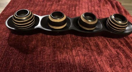 BRAND NEW, NEVER USED (4) BLACK AND BROWN STRIPED CANDLES WITH A BLACK CANDLE STAND