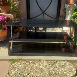 TV STAND GLASS AND METAL TABLE.