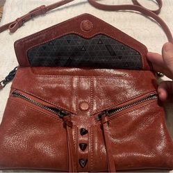 BOTKIER, NY TRIGGER Brown Leather CrossBody Bag with Studs & Fringes  Perfect as a crossbody or a clutch. You can easily transform this into a waist b