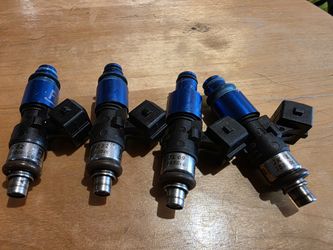 4 genuine Fuel Injector Clinic (FIC) 1650cc fuel injectors removed from a 2018 Subaru WRX STI.