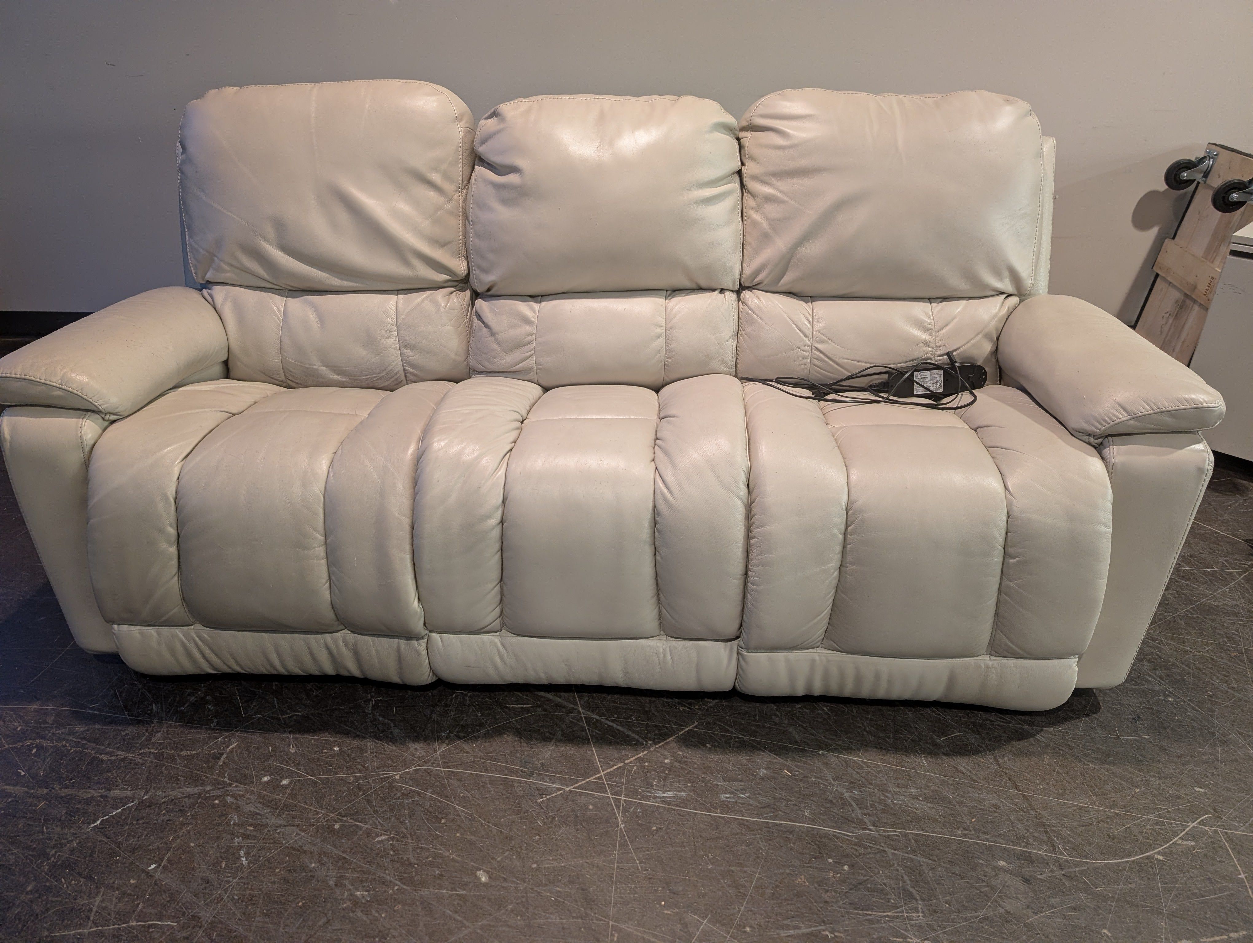Cream Upholstered Two-Seater Reclining Sofa