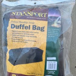 NEW in package. Canvas shoulder strap duffel bag 50”x30”.